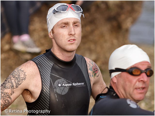 Triathlon Swimming Competitor Waiting to Enter the Water