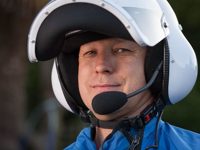 Portrait of Microlight Aircraft Pilot Wearing White Helmet and Blue Overalls