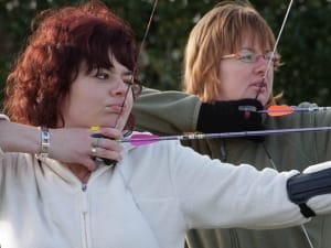 Female archery competitors in training