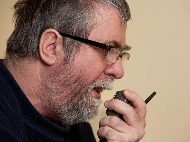 amateur radio ham talking on base station