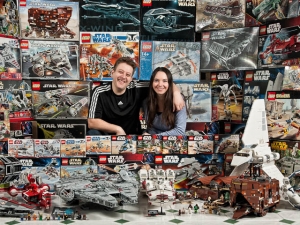 Star Wars Collectors Surrounded By Boxes And Models