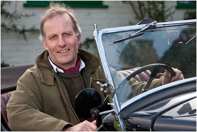 Man Sat At Wheel Of Morris Eight Classic Car