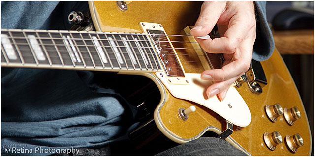 Close Up Of Guitarist Hand Playing Yellow Electric Guitar