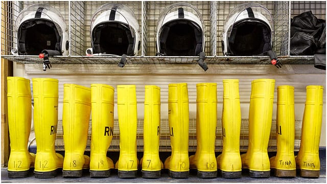 RNLI Portsmouth Lifeboat Station Yellow Boots And Safety Helmets in Crew Room