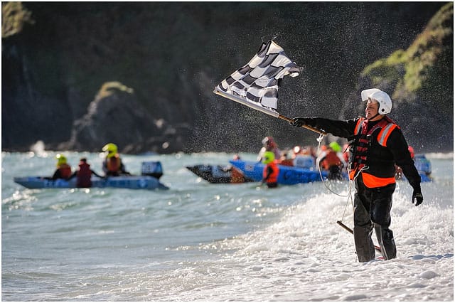 zapcat-race-official-waving-finish-flag Race Official Waving Flat On Shoreline At Zapcat P750 World Championships