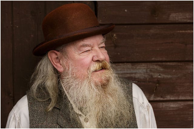 Head And Shoulders Portrait Of Man In American Wild West Tweed Waistcoat And Brown Bowler Hat