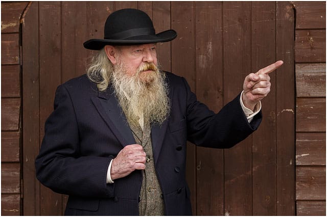 Portrait Of Wild West Preacher Dressed In Black And Pointing