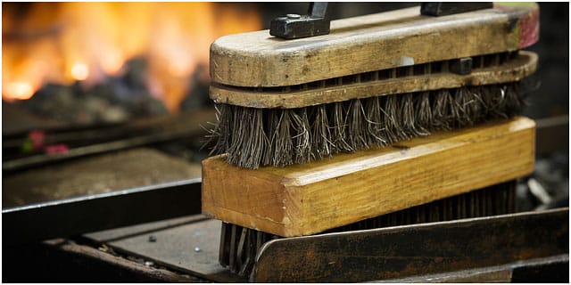 Blacksmiths wire brushes on edge of forge Blacksmiths Wire Brushes On Edge Of Forge