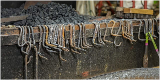 Metal Hooks Hanging From The Edge Of The Forge