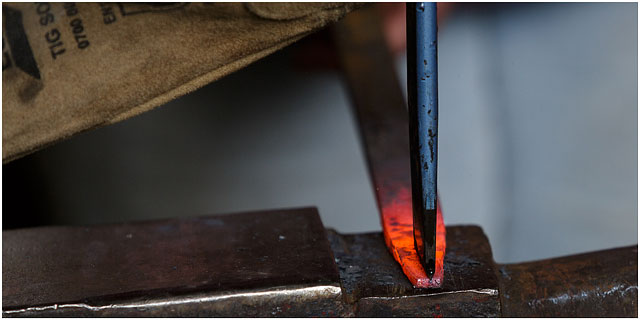 Splitting The End Of A Red Hot Metal Bar In Blacksmiths Workshop