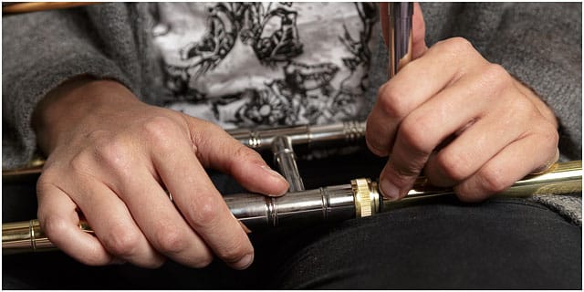 Close Up Of Female Hands Holding Brass Trombone