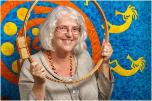 Headshot Portrait Of Textile Artist Framed By Wooden Quilting Hoop