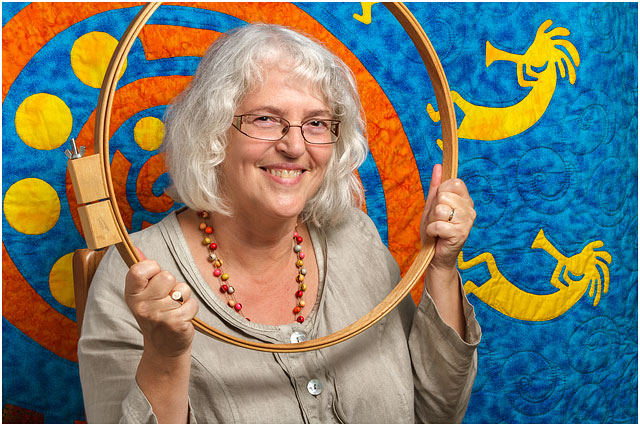 Headshot Portrait Of Textile Artist Framed By Wooden Quilting Hoop 