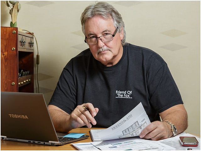 Laptop Man Black T-shirt Glasses Paperwork Office 