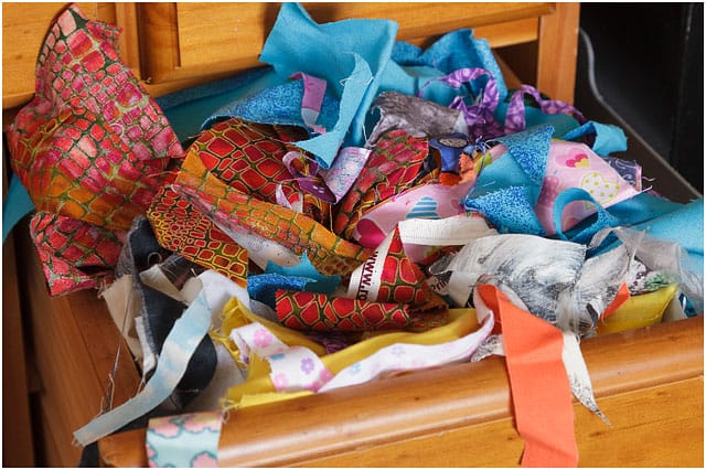 Various Fabric Offcuts Overflowing From Wooden Office Drawer 