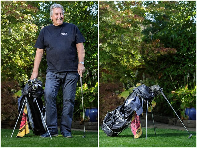 Golf Bag Man Standing Blue Trousers Dappled Shade Black T-shirt Foliage Background 