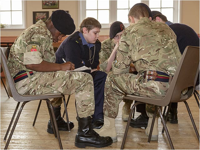 TS Active Marine Training Corps cadets sat in a group for team exercises