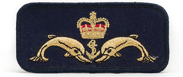 Royal Navy submariners cloth uniform badge featuring dolphins an anchor and a crown.