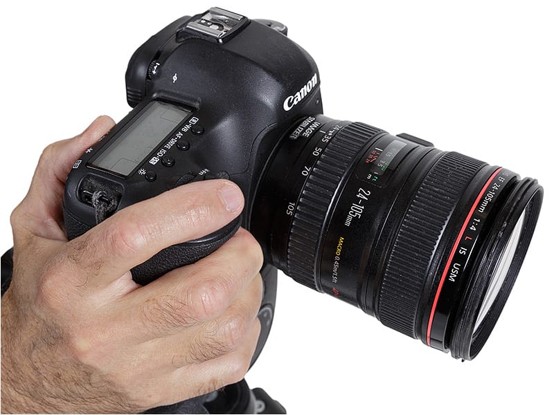 Hand holding DSLR camera Hand holding a DSLR camera
