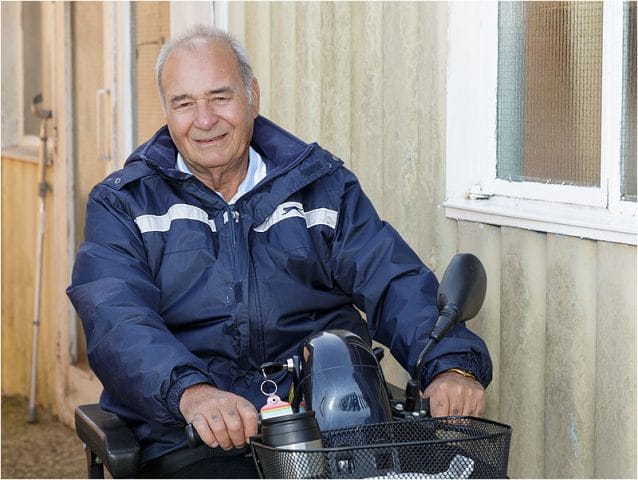 Portrait of motability scooter user outside the Havant Men’s Shed 