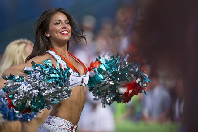 american female cheerleader with pom pom