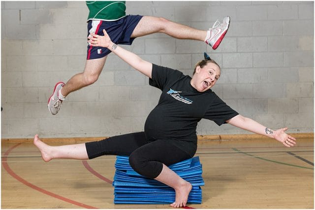 Two members of the Portsmouth Warriors Cheerleading Squad joking around 