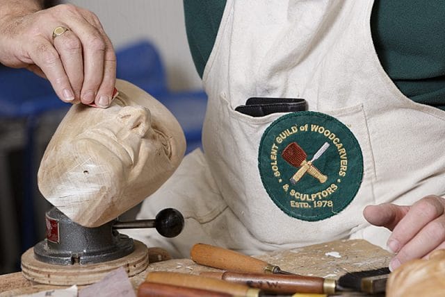 close up of woodcarver at work during a solent woodcarver and sculptors guild carve-in 