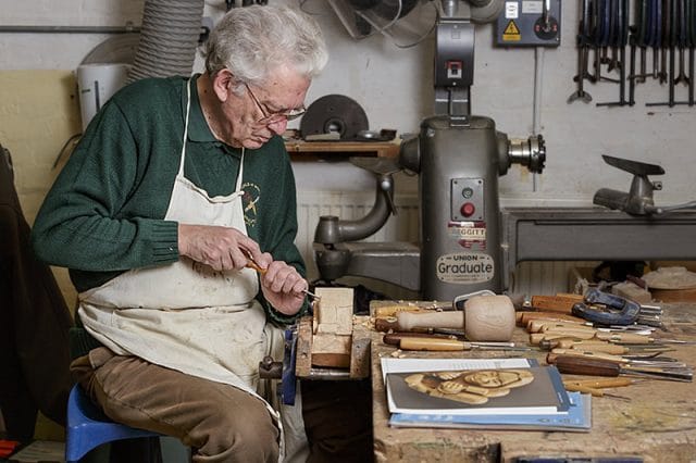 Solent guild woodcarver member carving a gargoyle 