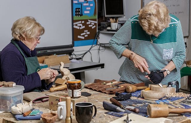 Two female woodcarvers in workshop 