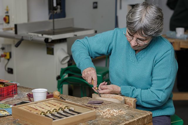 female woodcarver with personal carving project 