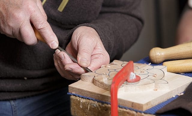 close up of woodcarver at carve-In day for solent guild of woodcarvers and sculptors at portsmouth grammar school 