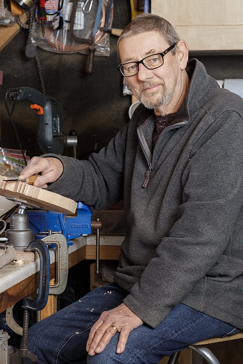 portrait of paul barton a member of the solent guild of woodcarvers and sculptors at home in his workshop 