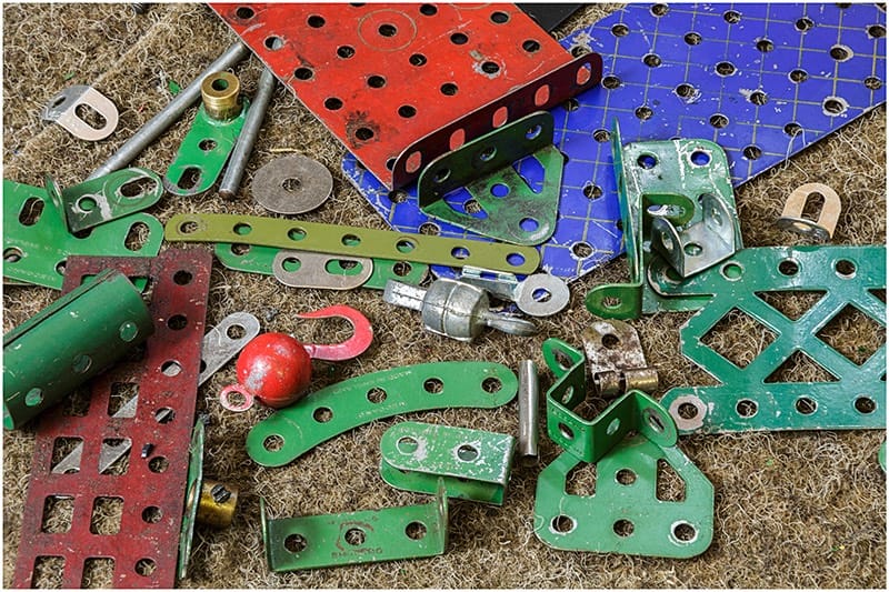 Collection of original Meccano parts in a pile