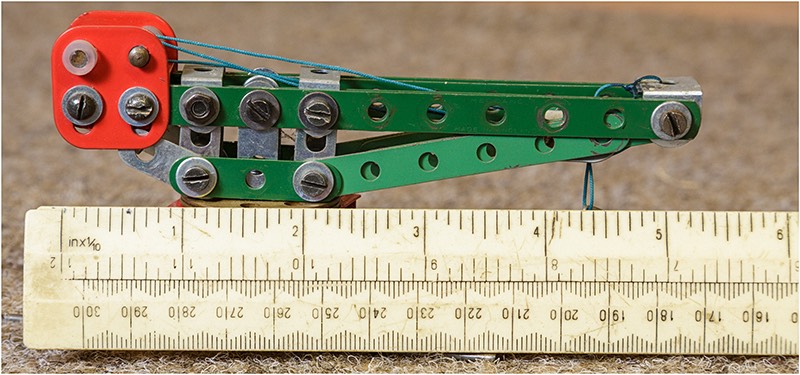 Small scale Meccano model crane with ruler