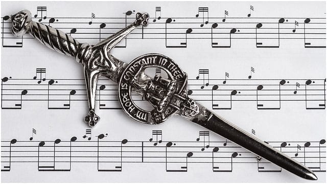 Scottish Bagpipe Music Notation With Ceremonial Dirk