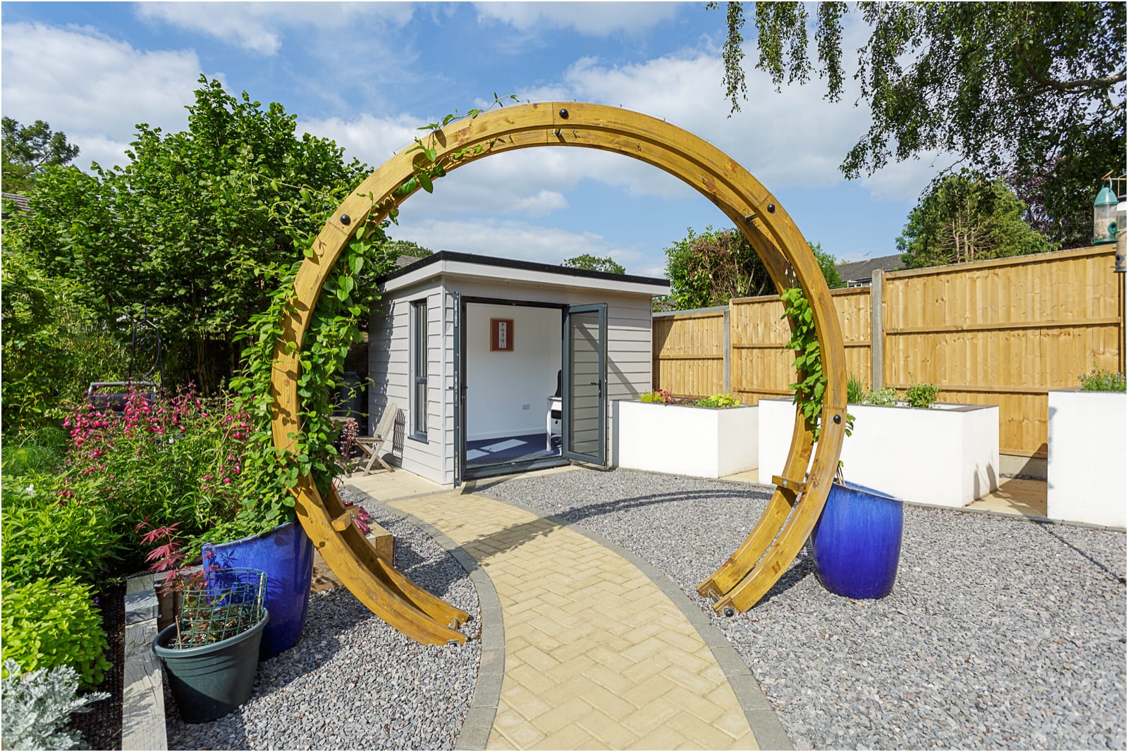 residential property moongate archway with flowers leading to garden office room