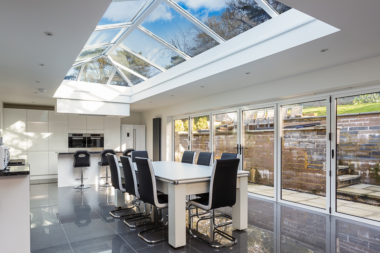 light, bright, modern kitchen with fully glazed roof and windows in a residential property
