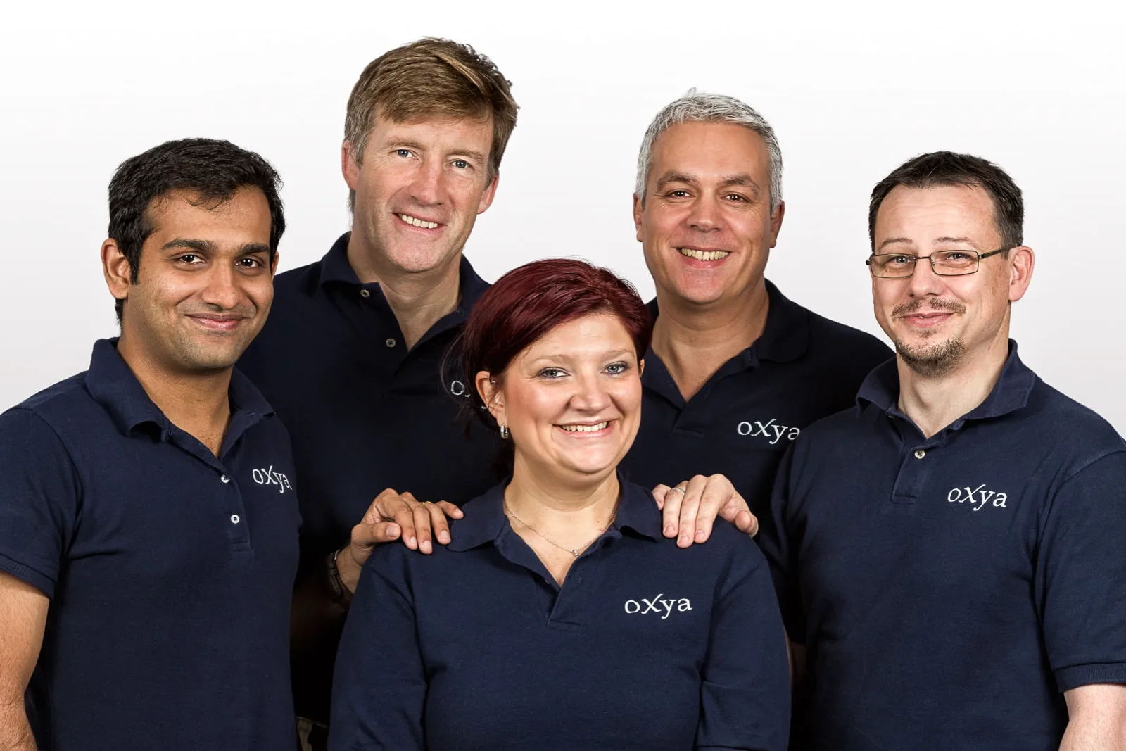 group team business portrait of four males and one female against white background