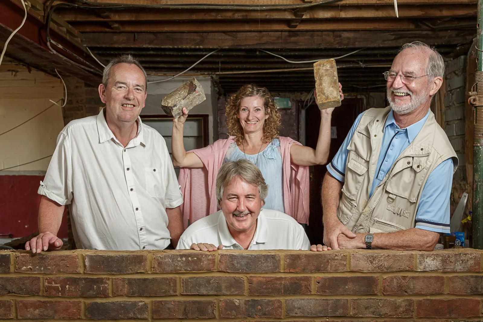 promotional portrait of the members of a local co-operative organised to save the closure of a village public house