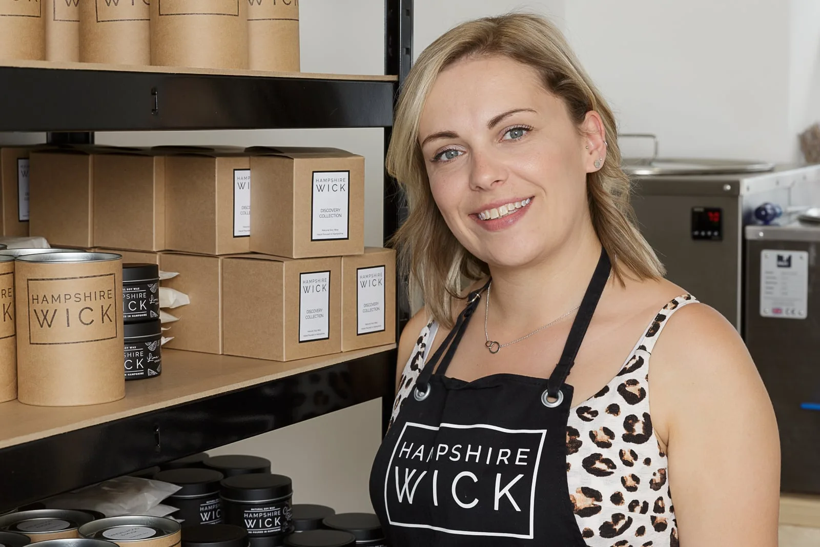 social media marketing portrait of a young blonde female business owner with some of her products