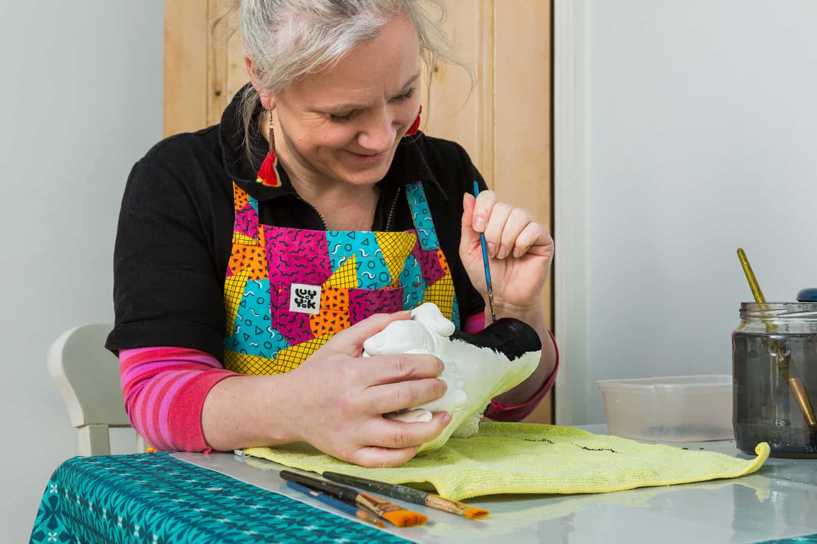 portrait of the business owner of sentimental castings painting her artwork