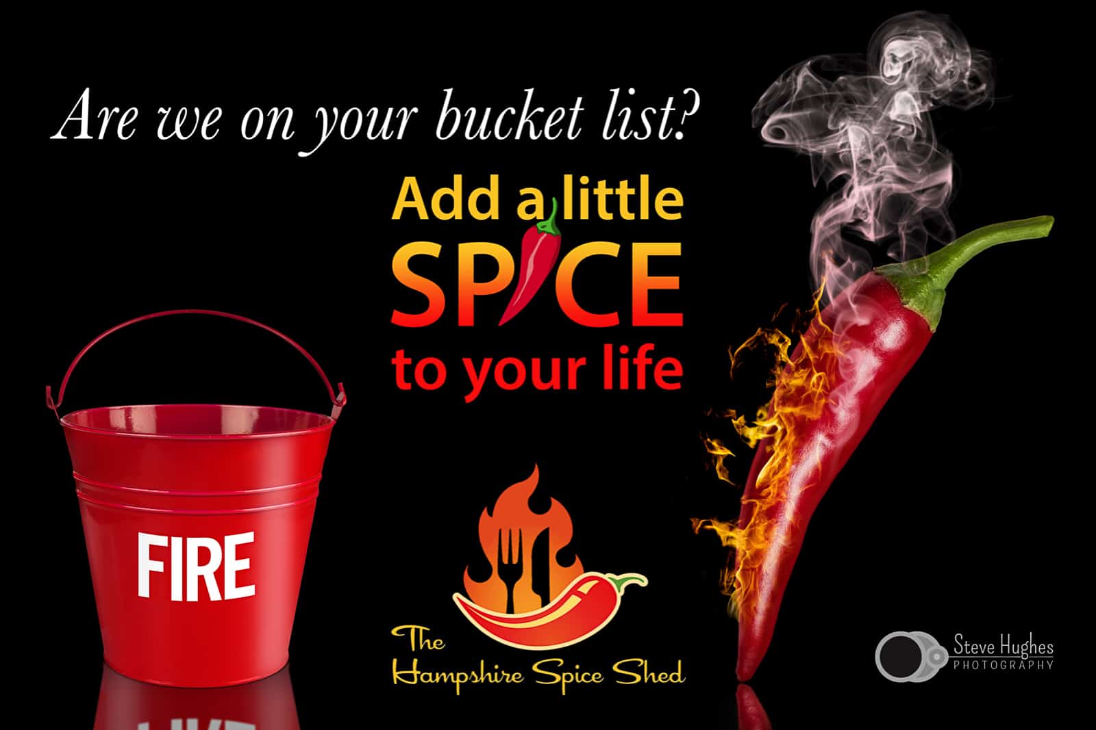 composite photograph of smoking red chillie pepper and red fire bucket on black background