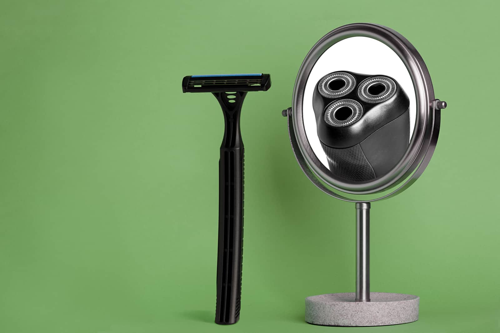 composite photograph of black wet shave razor and electric razor in mirror on green background