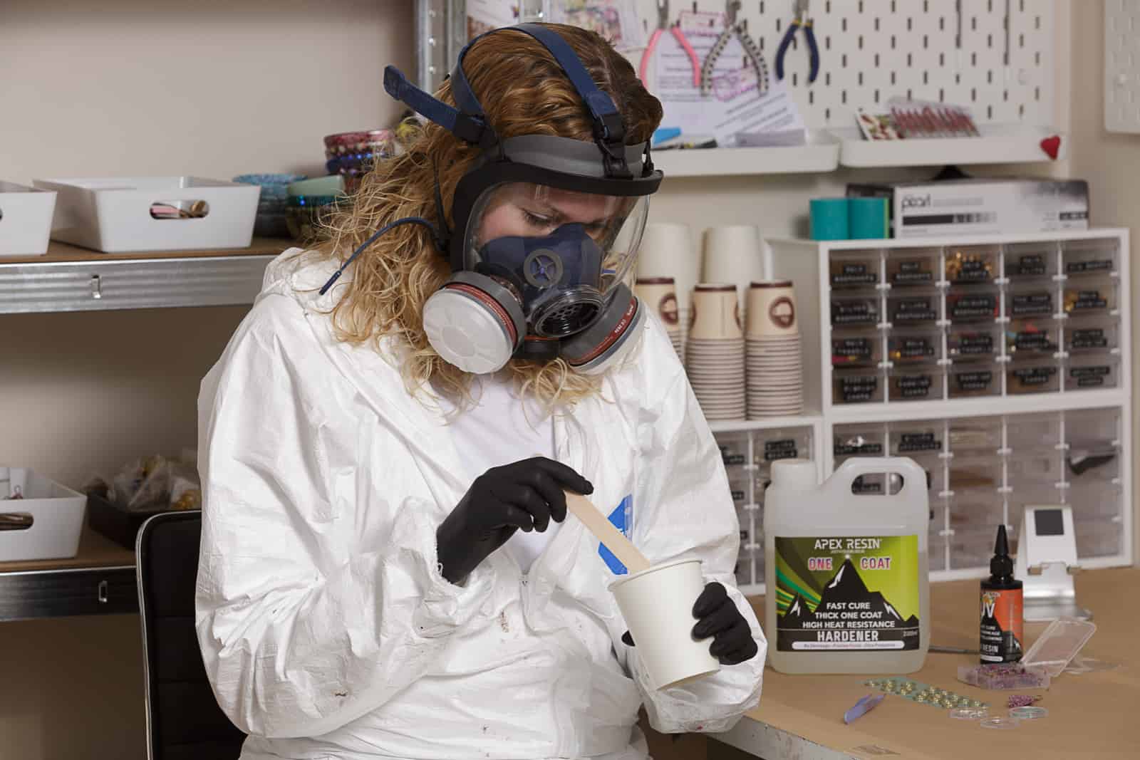 petal and plume owner wearing HAZMAT protective clothing whilst mixing resin chemicals