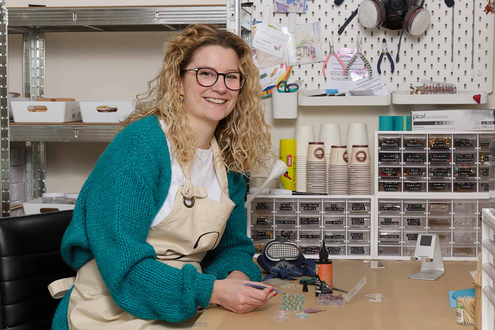 portrait of petal and plume owner at her workbench