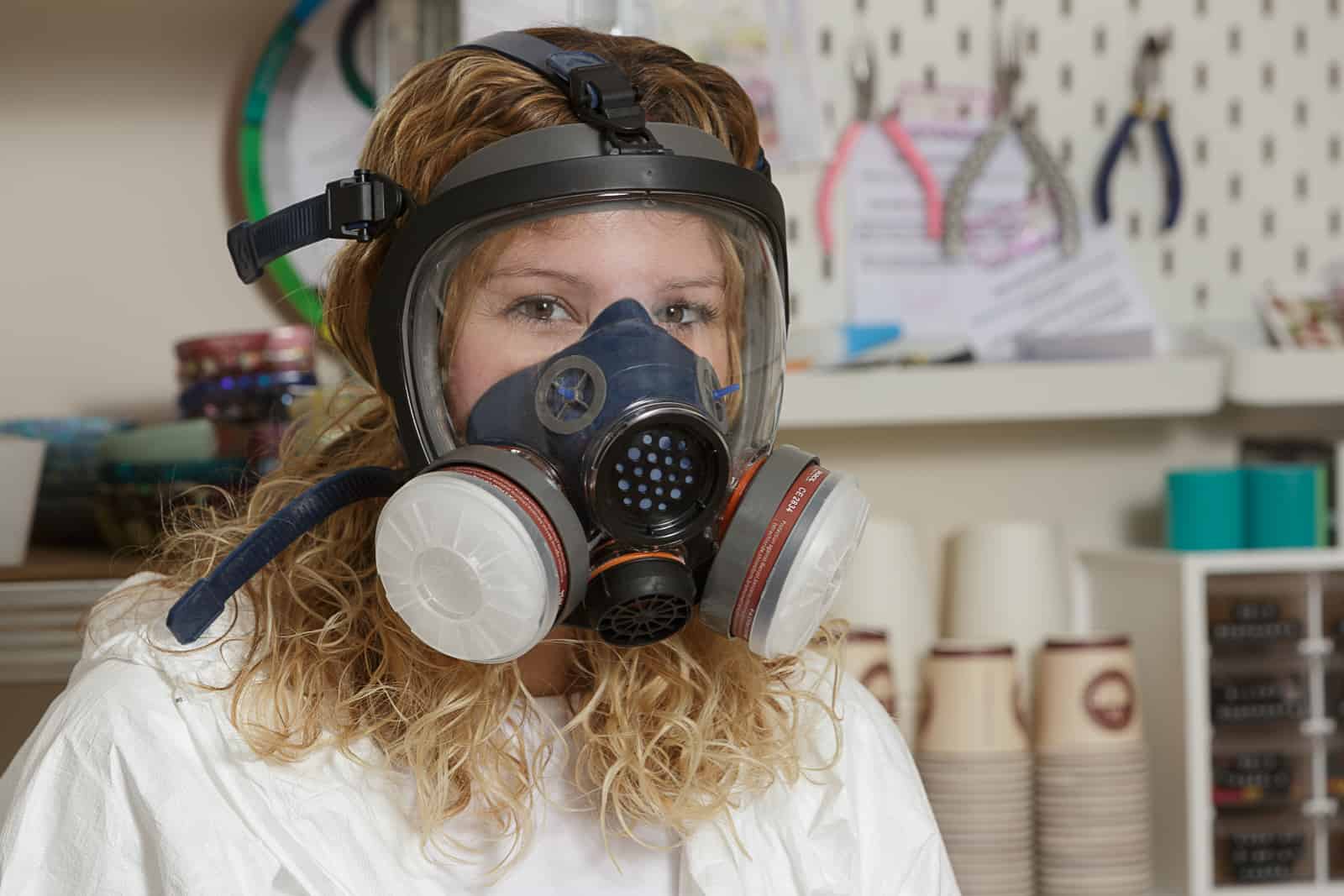 Portrait of petal and plume business owner wearing HAZMAT protective clothing