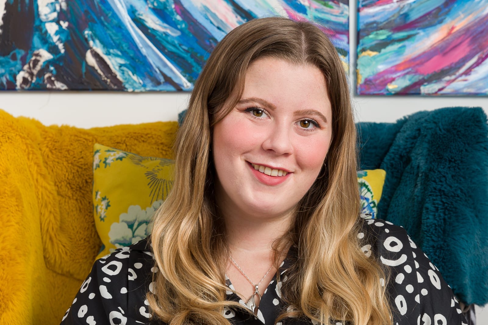 informal female portrait with artwork in the background